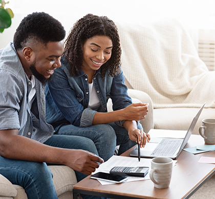 Smiling Couple Discussing Budgeting